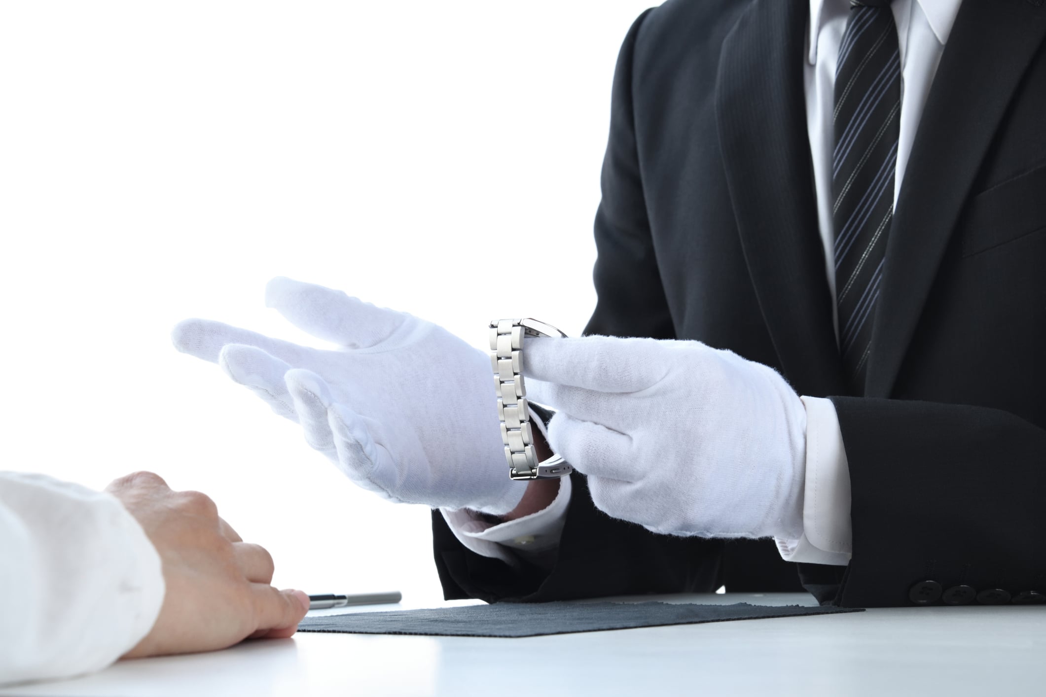 Appraiser checking value and quality of wristwatch